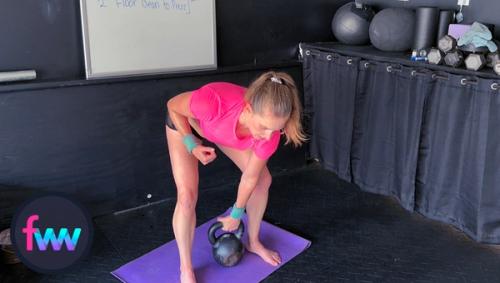 Kindal at the bottom of the floor clean. You can see she is in a hip hinge and ready to pull hard on the kettlebell.