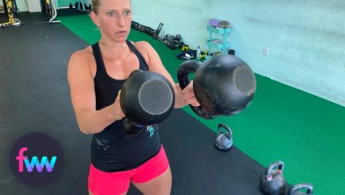 Kindal showing the two mismatched kettlebells during the swing.