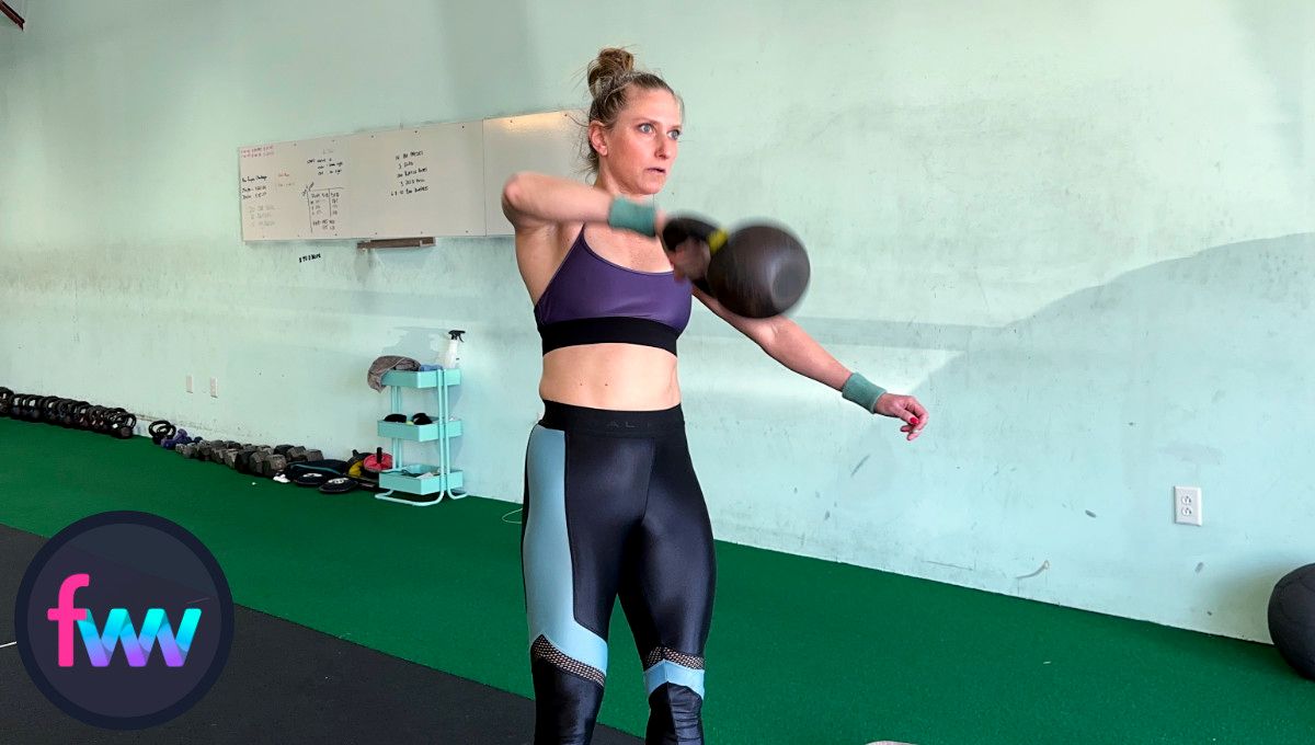 Kindal tugging up on the kettlebell and keeping her elbow high as she gets into the loaded position of the high pull.