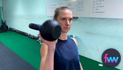 Kindal holding a kettlebell palmed.