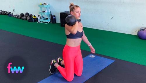 Kindal at the bottom of the prisoner squat with a racked kettlebell.