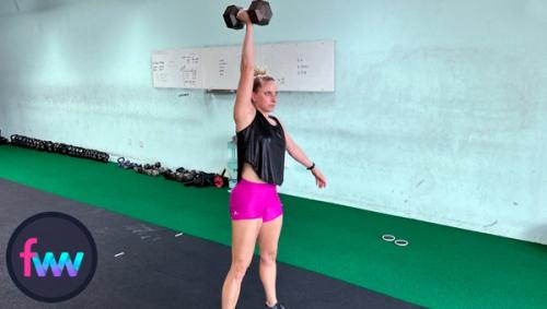 Kindal fully extending the dumbbell over her head and still maintaining good balance through her feet.