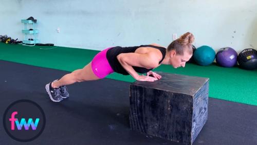 Kindal showing the bottom of a diamond pushup from a lower box.