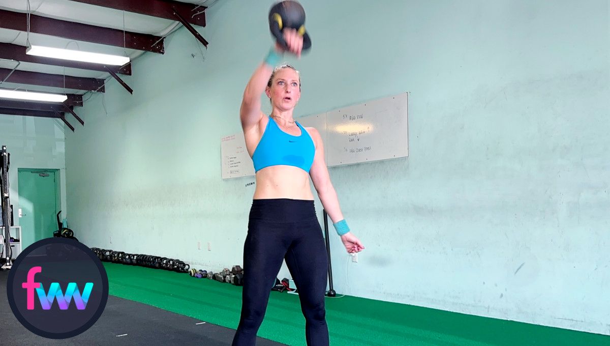 As the kettlebell reaches about chest height or slightly above, Kindal punches around the kettlebell so it lands softly on her forearm.