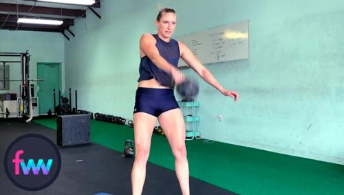 Kindal redirecting the kettlebell so it goes straight up allowing her to get in position to punch around the bell.