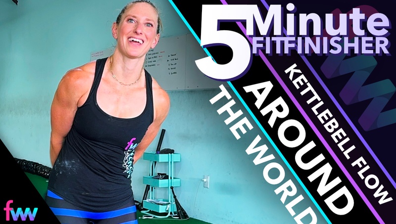 Kindal smiling as she rotates a kettlebell around her body doing the exercise called around the world.