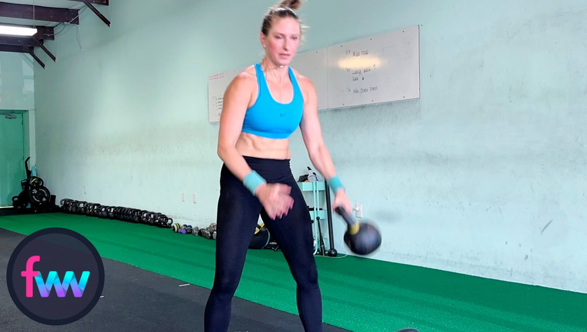 Kindal fires up from the kettlebell pass creating momentum to sling the kettlebell around her hips and up to her opposite shoulder.