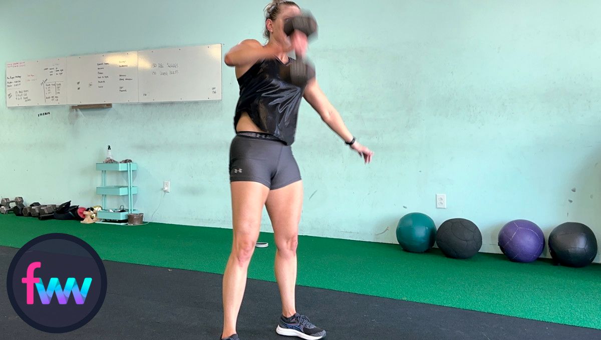 Kindal's elbow stops and comes down a little. This is the start of the transition so she can then get the dumbbell over her head. Notice her legs are locked with all power going up.