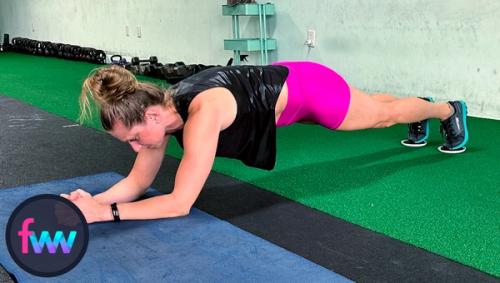 Kindal in the core engaged part of the plank rockers with her shoulders behind her elbows. Her core is fully pulled in and tight.