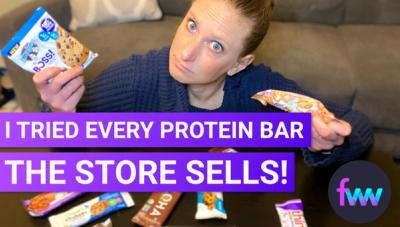 Kindal at a table surrounded by protein bars
