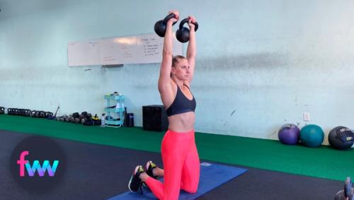 Kindal pressing kettlebells at the bottom of the prisoner squat.