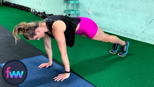 Kindal in the top of a pushup position with her feet on sliders. Notice how her shoulders are past her hands a little.