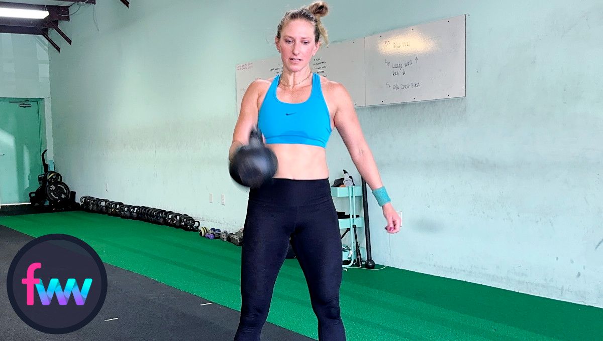 Kindal punching around the kettlebell as it passes her chest. The punch is her taking control so the bell lands gently on her forearm in the full racked position.