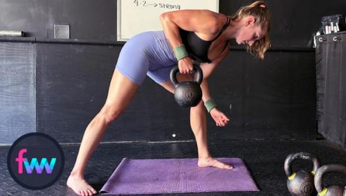 Kindal at the top of bent over rows having pulled the weight as high as she can get it towards her chest and pulling her core in for support.