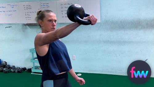 Kindal holding a kettlebell punched.