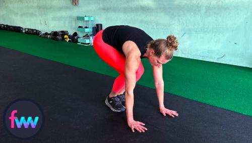 Kindal going down into the burpee and getting ready for her jump back into the pushup.