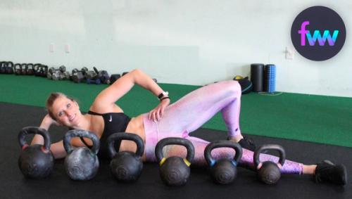 Kindal lounging behind some of our kettlebells.