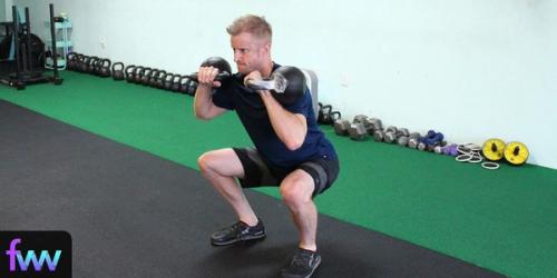 Dan squatting with two kettlebells being intense but not crazy
