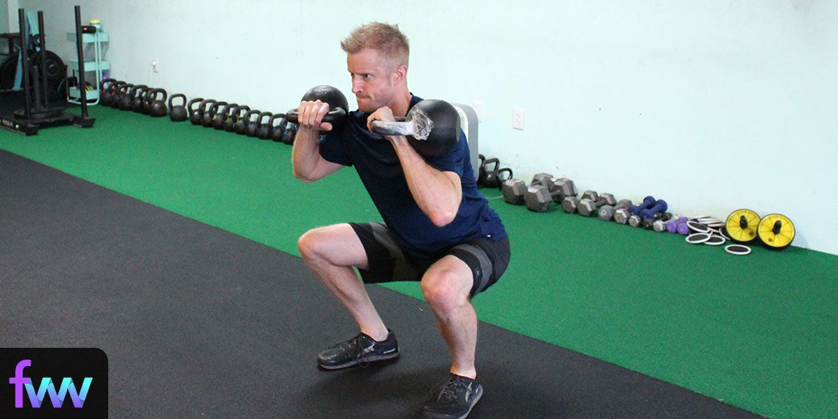 Dan squatting with two kettlebells being intense but not crazy