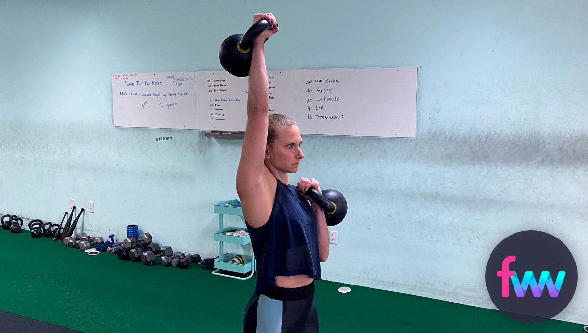 Kindal holding a kettlebell in rack and overhead.