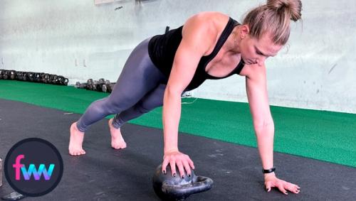 Kindal at the top of uneven pushups with a locked out body and her shoulders over her wrists.