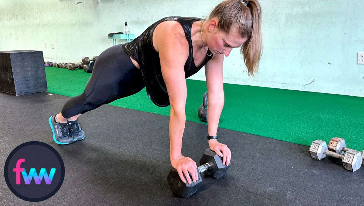 Kindal at the top of dumbbell close grip pushups. Her hands are on the dumbbell and her body and legs are fully engaged.