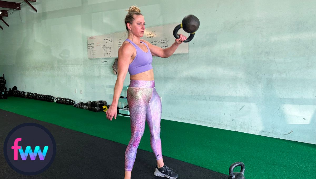 Kindal is at the midway point of the kettlebell snatch. Notice the elbow is close to the body as she is about to punch through the kettlebell.