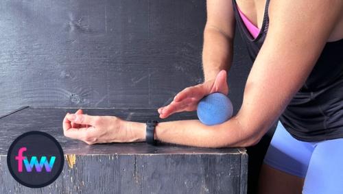 Kindal using the trigger ball to smash the bottom of her forearm. This can help release the forearm muscles providing a little more mobility to the elbow.