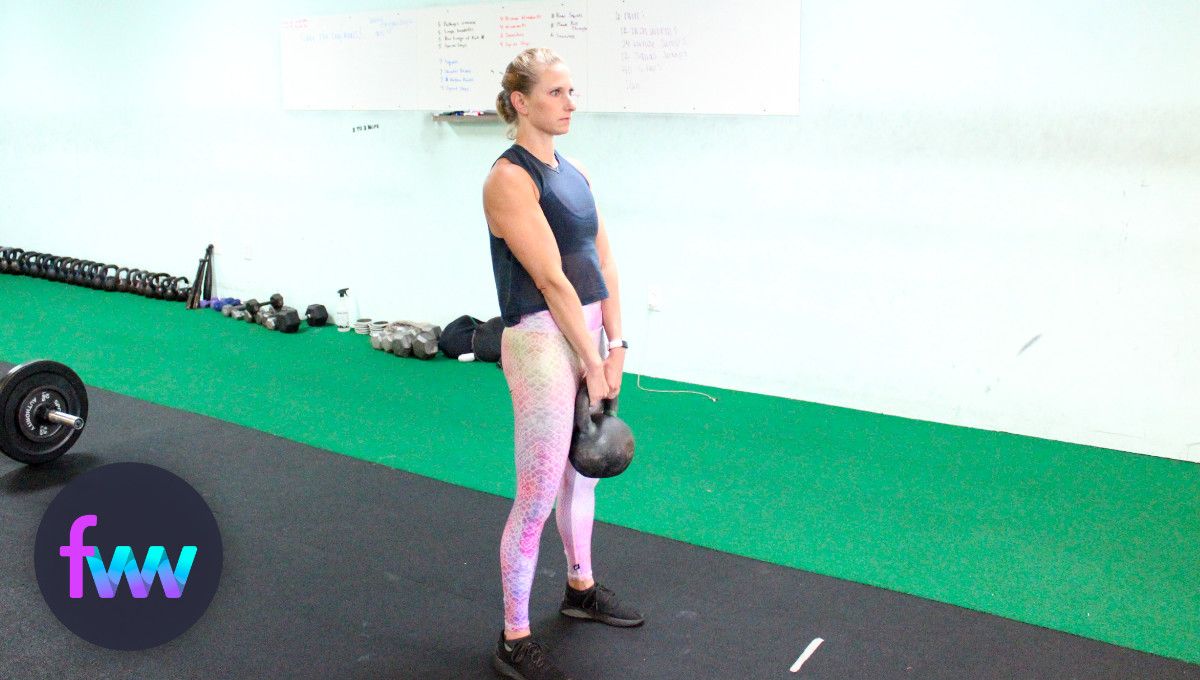 Kindal at the top of a kettlebell deadlift