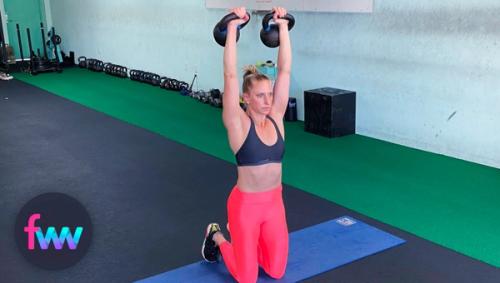 Kindal at the bottom of the overhead weighted prisoner squat.