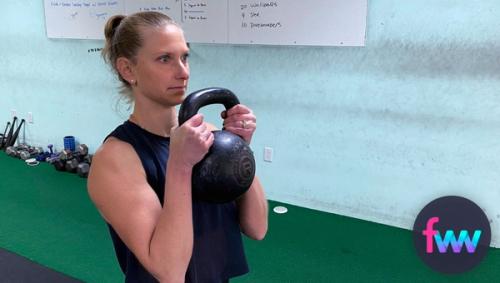 Kindal holding a kettlebell goblet style.