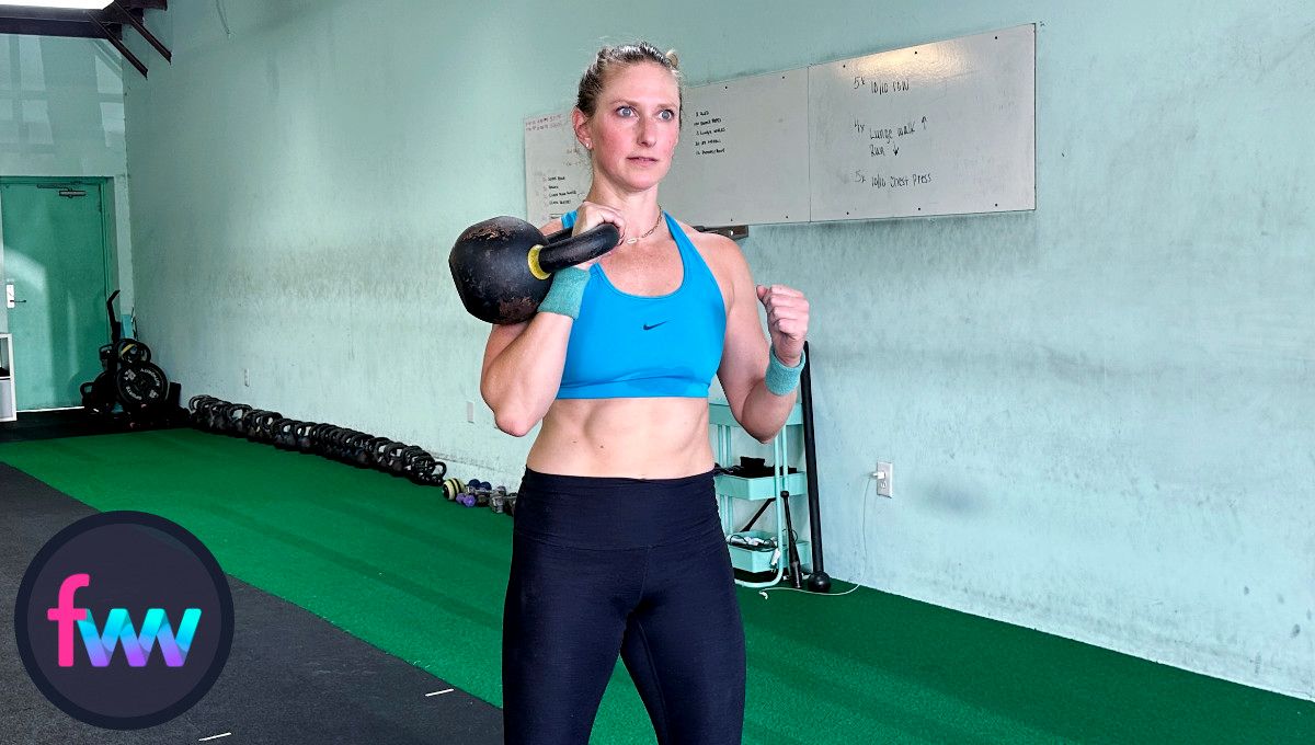 Kindal in a strong rack position with her body engaged and ready to push out and up to get the kettlebell above her head.