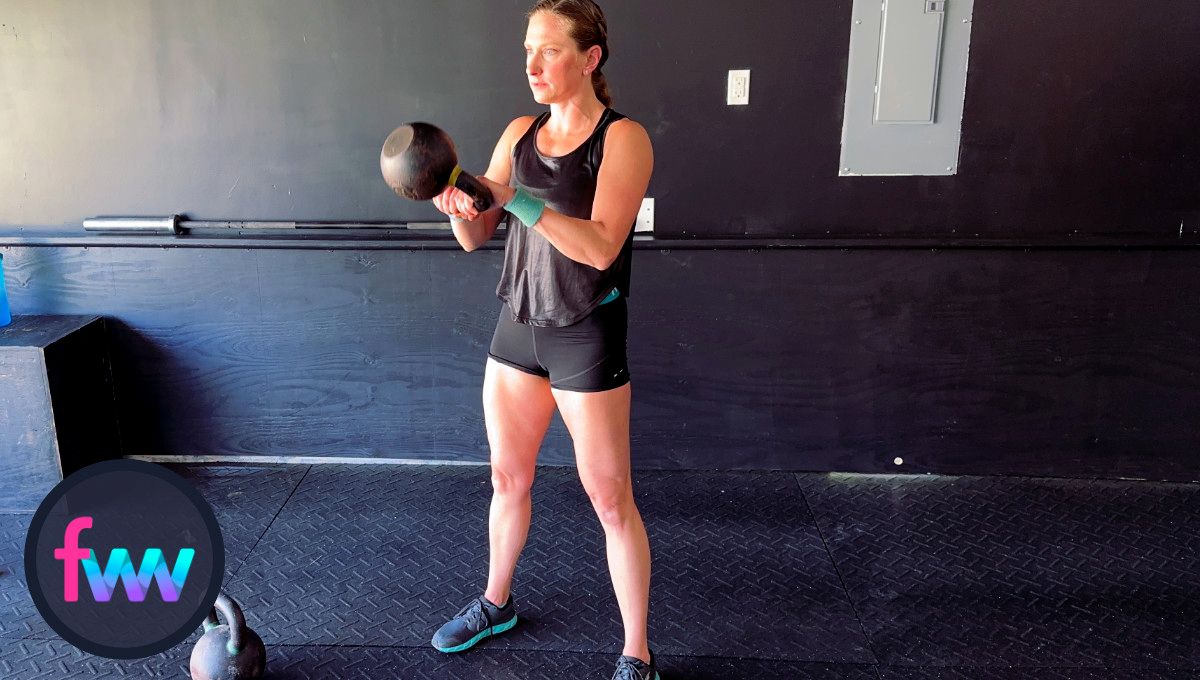 Kindal at the top of the kettlebell swing. Her legs are fully locked out and her core is tight. Kindal's balance is also near perfect at the top of the swing.