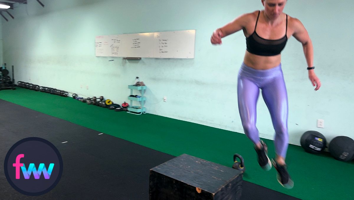 Kindal is jumping off the box and getting ready to land softly so she can go straight into the next burpee.