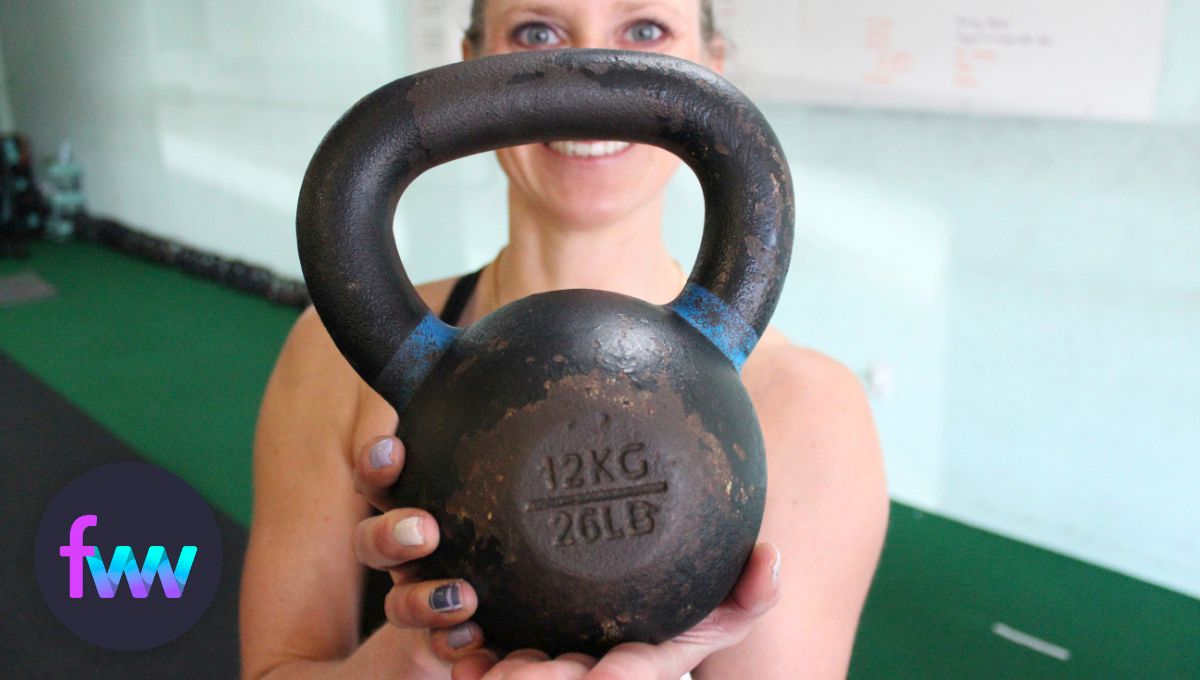 Kindal holding one of our 26 lb kettlebells.