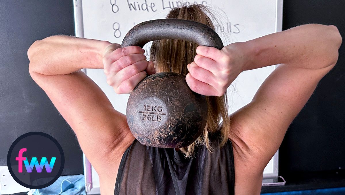 Kindal showing what the kettlebell looks like when it's behind your head. The kettlebell is actually upright and pulling your shoulder open.