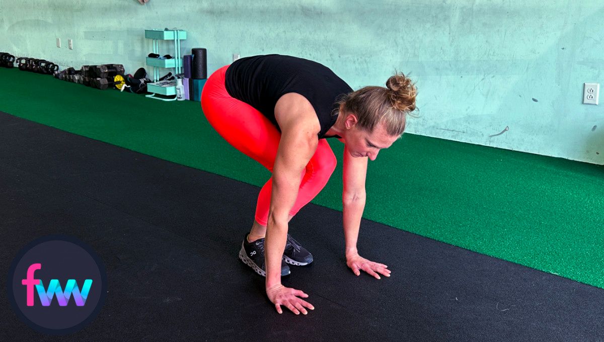 Kindal jumping back into a tuck position after her burpee pushup. She is ready to explode and complete the rep.