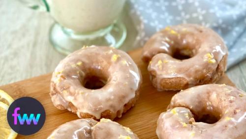 A plate of 4 healthy lemon strawberry donuts and milk