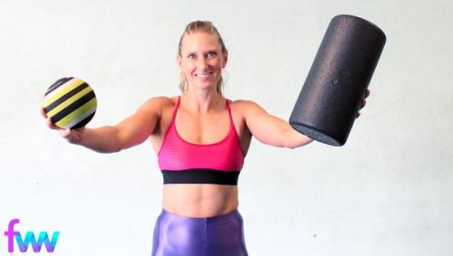 Kindal holding up a trigger ball and a foam roller.