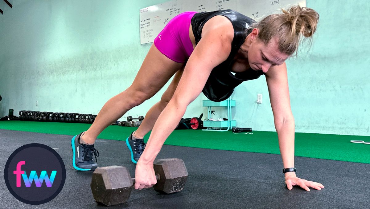 Kindal trying to hold her body straight and gently placing the dumbbell on the ground to complete the pull through.