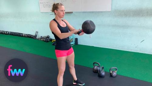 Kindal showing the top of a kettlebell swing.