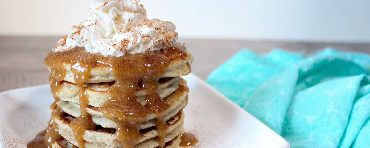 Cinnamon Vanilla Gluten Free Pancakes A stack of gluten free cinnamon vanilla pancakes with sugar free whip on top