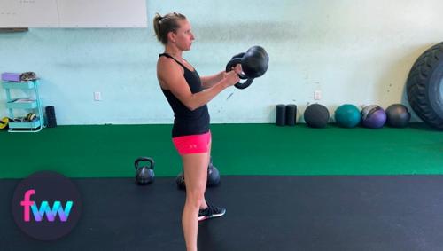 Kindal show how shoulders should stay packed with double kettlebell swings.