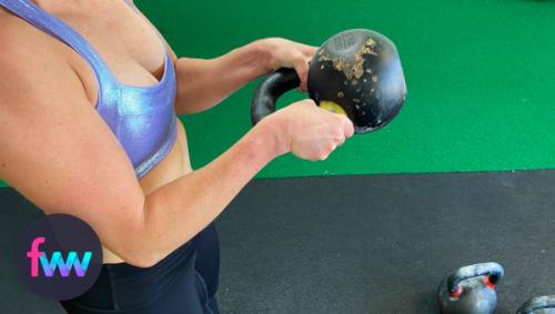 Kindal showing the kettlebell curl offset that makes it so tough.