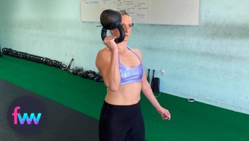 Kindal holding a kettlebell rack position but inverted.