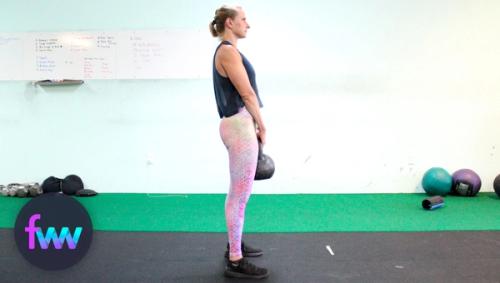 Kindal at the top of a kettlebell deadlift