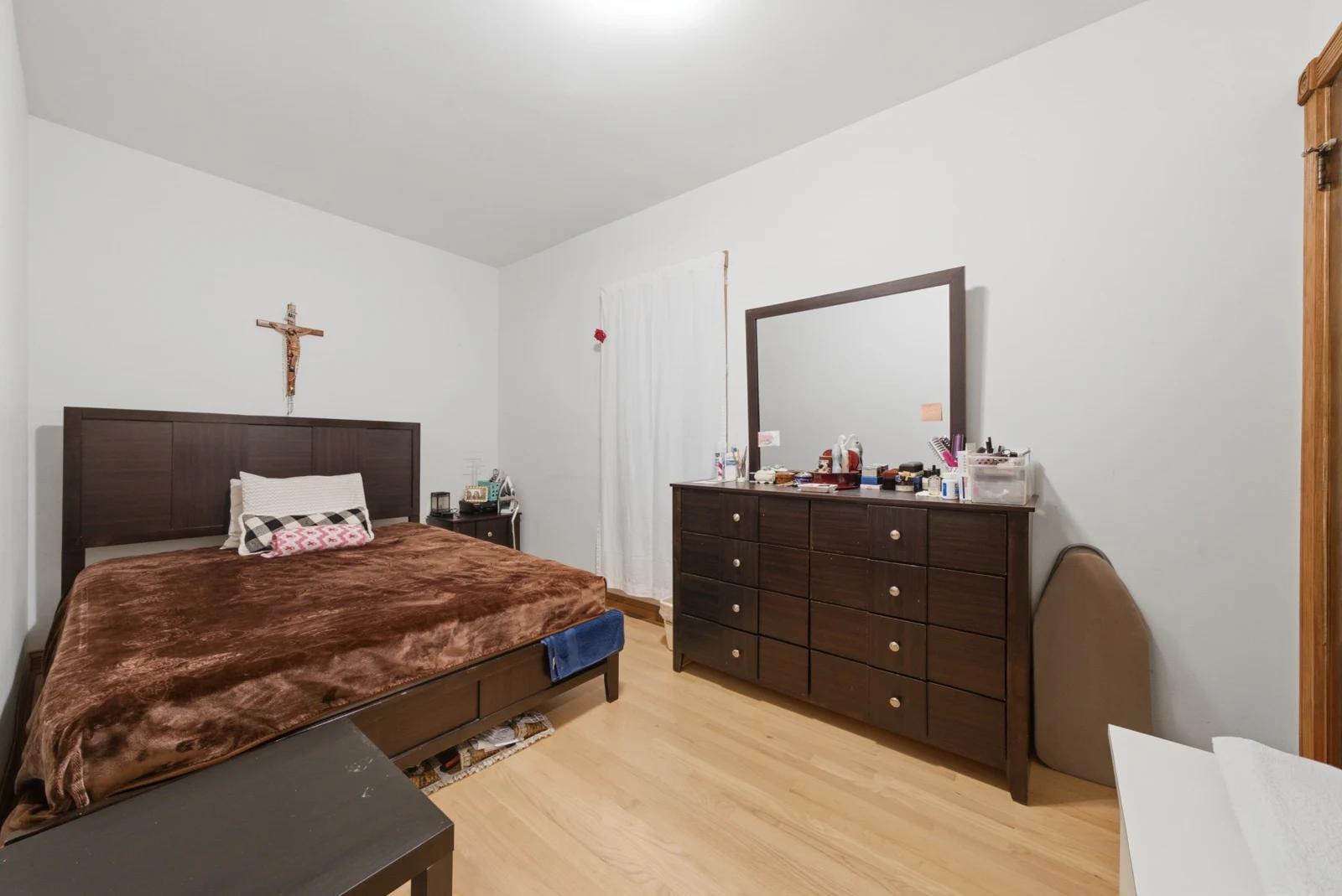 Bedroom with wood flooring