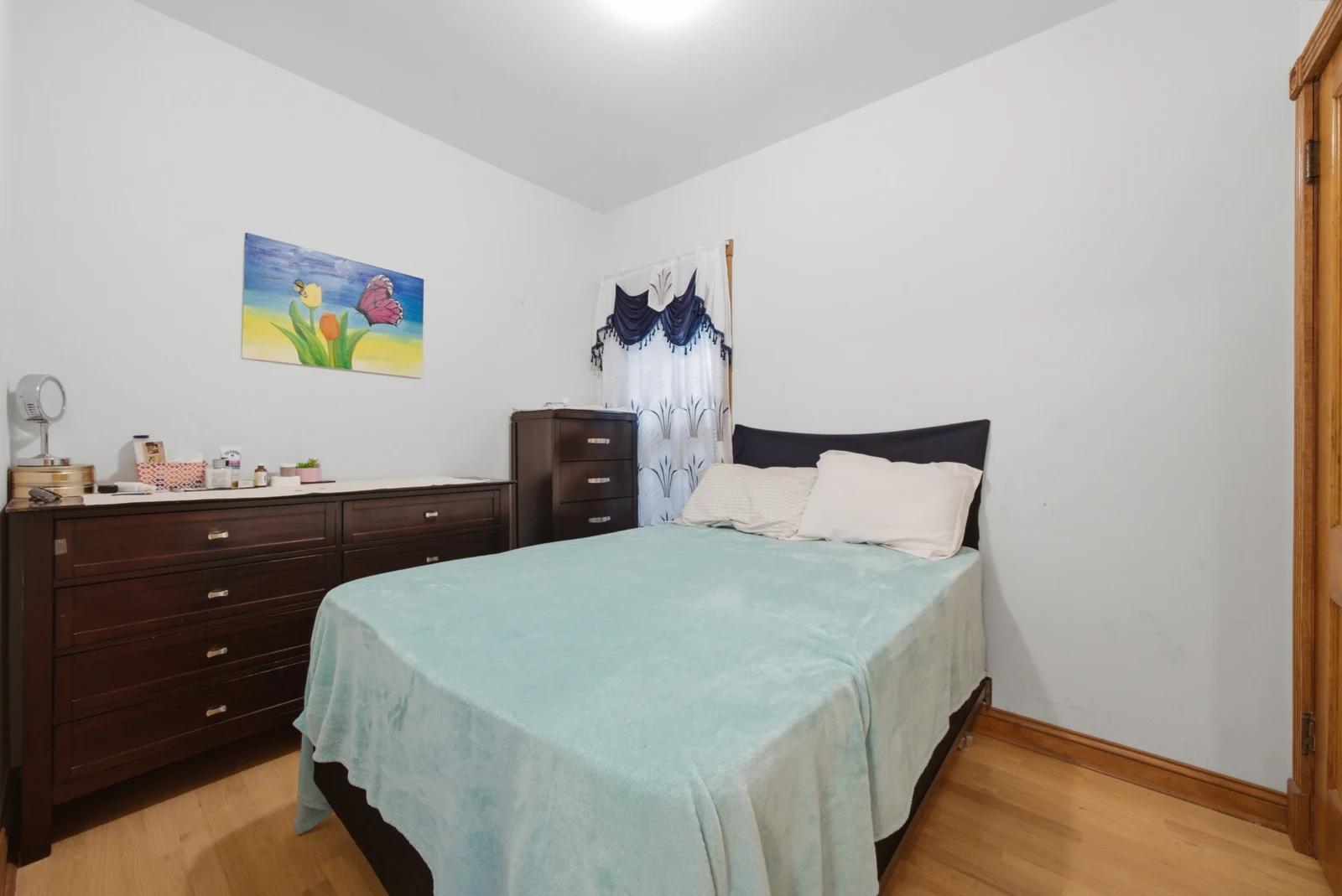 Bedroom with dresser and natural light