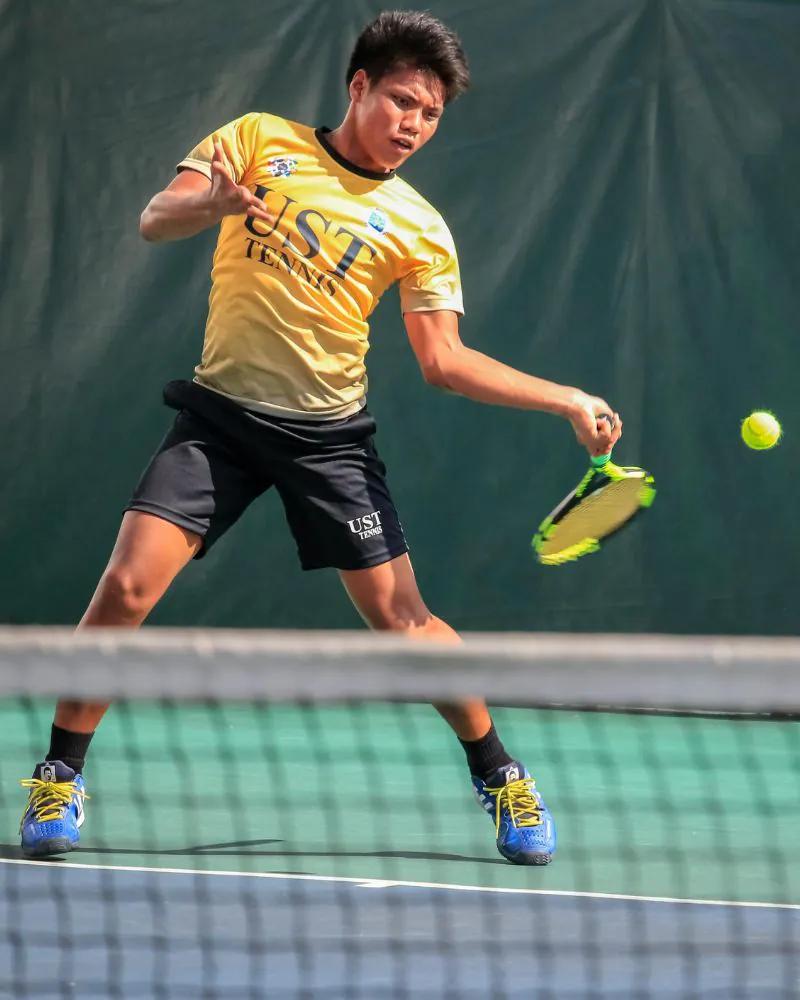 A tennis player striking a ball on court