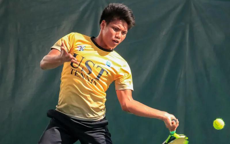 A tennis player striking a ball on court